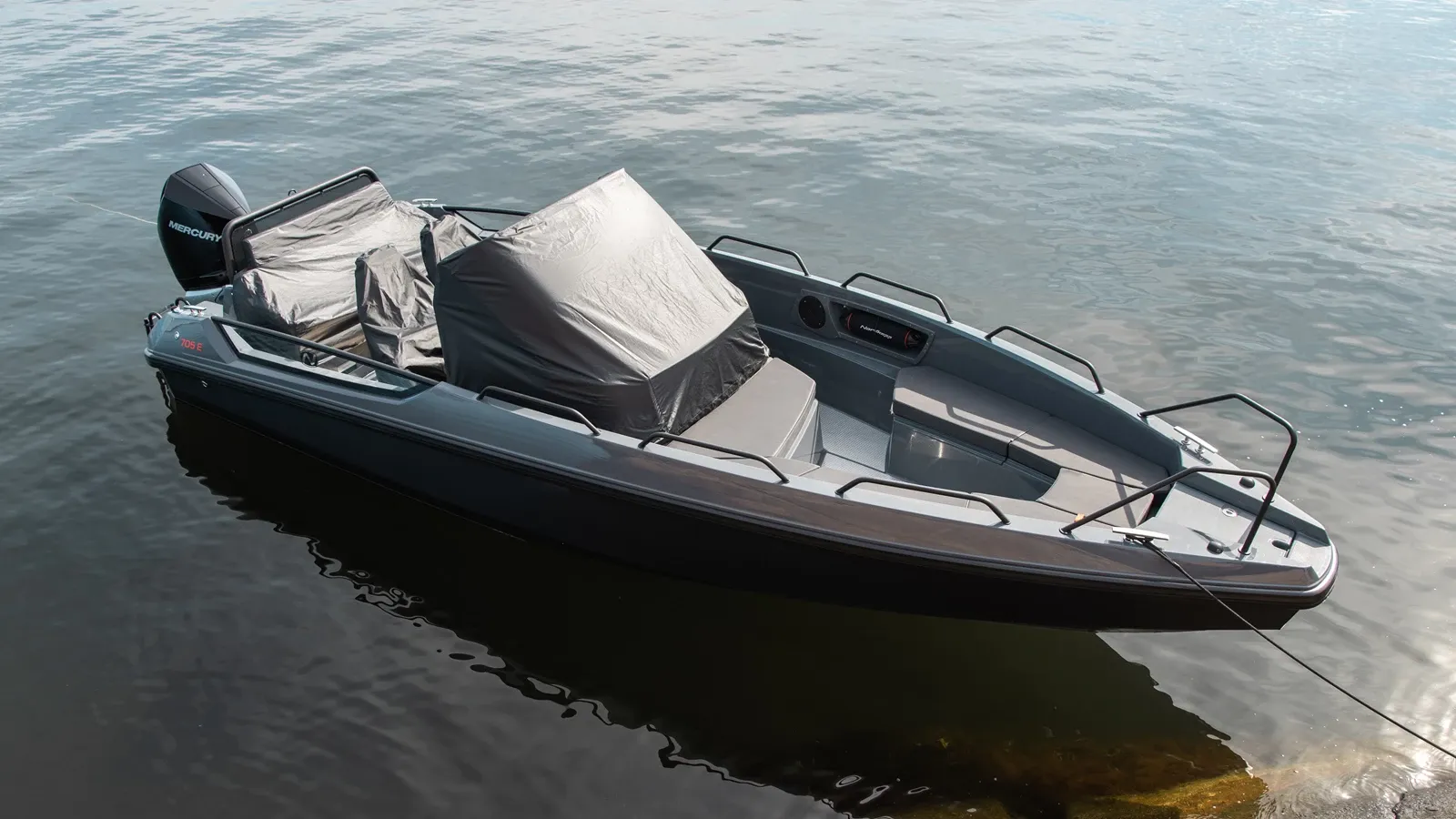 Nordkapp RS 705E on water with protective cover over console and seats